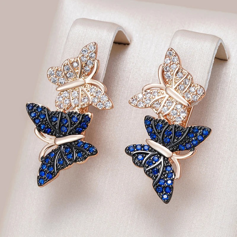 Orecchini pendenti con due farfalle in zircone naturale blu placcato oro rosa 18K