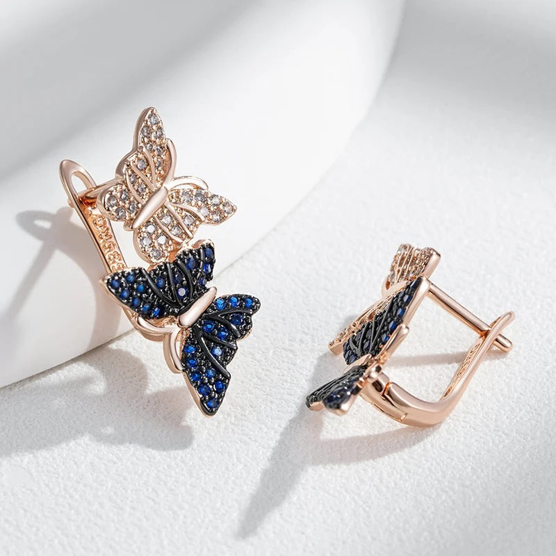 Orecchini pendenti con due farfalle in zircone naturale blu placcato oro rosa 18K