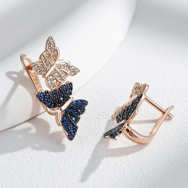 Orecchini pendenti con due farfalle in zircone naturale blu placcato oro rosa 18K