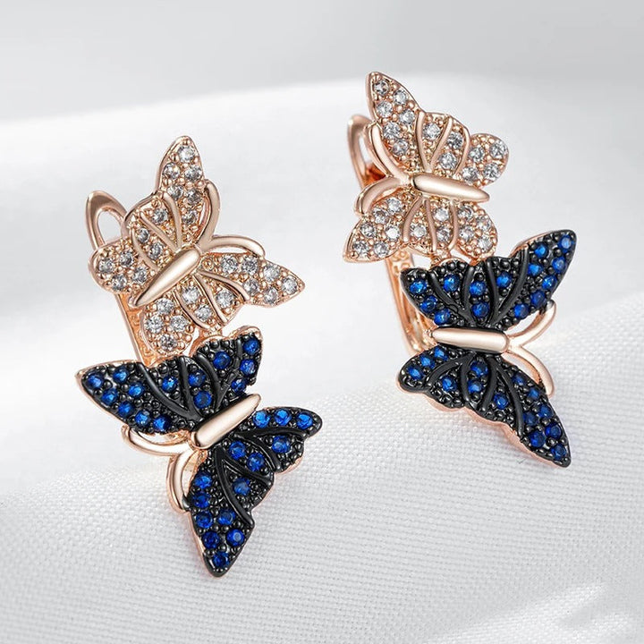Orecchini pendenti con due farfalle in zircone naturale blu placcato oro rosa 18K